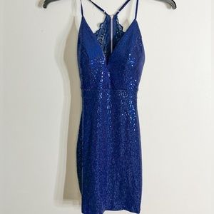 Blue mini dress with sequins and lace and open back.